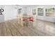 Bright dining room with glass table and red cushioned chairs at 401 N 1St St, Lake Mary, FL 32746