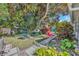 Landscaped backyard with a large magnolia tree and pathways at 4437 Elaine Pl, Orlando, FL 32812