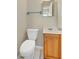 Compact half-bathroom with oak vanity and neutral walls with white trim at 4437 Elaine Pl, Orlando, FL 32812