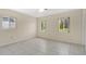 Bedroom featuring neutral paint, tile flooring and two bright windows at 4437 Elaine Pl, Orlando, FL 32812