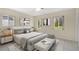 Bright, neutral bedroom featuring a white platform bed, modern art, and large windows at 4437 Elaine Pl, Orlando, FL 32812