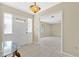 Inviting entryway with neutral colors, tile flooring, and decorative light fixture at 4437 Elaine Pl, Orlando, FL 32812