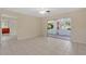 Bright living room showcasing tile flooring, large glass slider and access to outdoors at 4437 Elaine Pl, Orlando, FL 32812