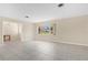 Bright living room features neutral walls, tile flooring, and large window with natural light at 4437 Elaine Pl, Orlando, FL 32812