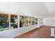 Enclosed sun room featuring large windows overlooking lush landscaping at 4437 Elaine Pl, Orlando, FL 32812