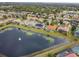 Aerial view showcasing lakefront homes with solar panels and pools at 4922 Kensington Park Blvd, Orlando, FL 32819