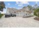 Home with stone exterior, three-car garage, and large driveway at 4922 Kensington Park Blvd, Orlando, FL 32819