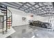 Extravagant garage with epoxy floor, custom cabinets, and a spiral staircase at 4922 Kensington Park Blvd, Orlando, FL 32819