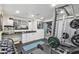 Home gym featuring weight machines, dumbbells, and a fitness area at 4922 Kensington Park Blvd, Orlando, FL 32819