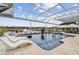 Luxury pool area with a covered patio and lounge chairs at 4922 Kensington Park Blvd, Orlando, FL 32819