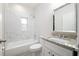 Clean bathroom with marble tile, bathtub, and granite vanity at 4924 College Dr, Orlando, FL 32811