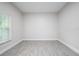 Spacious bedroom with grey tile floors and large window at 4924 College Dr, Orlando, FL 32811