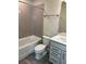 Bathroom with tub shower combo, grey tile and neutral cabinets at 5425 Log Grove Ln, Orlando, FL 32829