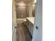 Bathroom with tub shower combo, grey tile and neutral cabinets at 5425 Log Grove Ln, Orlando, FL 32829