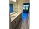 Double vanity bathroom with grey cabinets and quartz countertop at 5425 Log Grove Ln, Orlando, FL 32829