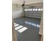 Attached garage with grey epoxy floor and white block walls at 5425 Log Grove Ln, Orlando, FL 32829