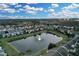 Aerial view of community with pond and homes at 558 S Terrace Spring Dr, Orlando, FL 32828