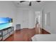 Bedroom with wood floors and large mirror at 558 S Terrace Spring Dr, Orlando, FL 32828