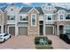 Two-story townhome with stone accents and a two-car garage at 558 S Terrace Spring Dr, Orlando, FL 32828