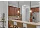 Kitchen with breakfast bar and dark wood cabinets at 558 S Terrace Spring Dr, Orlando, FL 32828