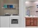 Laundry room with washer, dryer, and shelving at 558 S Terrace Spring Dr, Orlando, FL 32828