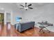 Loft space with L-shaped sofa, hardwood floors, and mounted TV at 558 S Terrace Spring Dr, Orlando, FL 32828