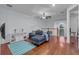 Bright loft area with L-shaped sofa, wood floors, and mounted TV at 558 S Terrace Spring Dr, Orlando, FL 32828