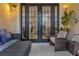 Relaxing patio with wicker furniture and view of the interior at 558 S Terrace Spring Dr, Orlando, FL 32828