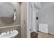 Small powder room with oval mirror, sink, and white vanity at 558 S Terrace Spring Dr, Orlando, FL 32828