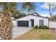 Modern house exterior with gray siding, dark gray garage door, and paved driveway at 722 W Kaley Ave, Orlando, FL 32805