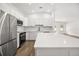 Modern kitchen with white shaker cabinets, stainless steel appliances, and quartz countertops at 722 W Kaley Ave, Orlando, FL 32805