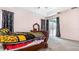 Bright bedroom with a queen bed, sliding glass door, and dark curtains at 728 Longford Loop, Apopka, FL 32703