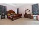 Main bedroom with large wood bed frame and mirror at 728 Longford Loop, Apopka, FL 32703