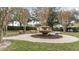 Landscaped courtyard with a fountain and park benches at 728 Longford Loop, Apopka, FL 32703