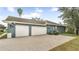 Three-car garage with gray exterior and brick paver driveway at 728 Longford Loop, Apopka, FL 32703