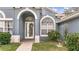 Front entryway with arched windows and a glass door at 728 Longford Loop, Apopka, FL 32703