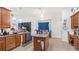 Eat-in kitchen with island and views to dining area at 728 Longford Loop, Apopka, FL 32703