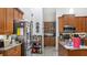 Modern kitchen with stainless steel appliances and island at 728 Longford Loop, Apopka, FL 32703