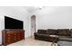 Spacious living room featuring a large TV and comfortable sectional sofa at 728 Longford Loop, Apopka, FL 32703