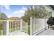 Backyard access from covered patio with white railing at 728 Longford Loop, Apopka, FL 32703