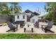 A spacious backyard features a lounge area with a hot tub, several chairs, and a small table at 832 N Summerlin Ave, Orlando, FL 32803