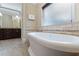 Bright bathroom boasts a soaking tub and tiled flooring, creating a relaxing and luxurious atmosphere at 832 N Summerlin Ave, Orlando, FL 32803