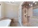 Bathroom featuring a stand-up shower with glass door and beige brick-patterned tile at 832 N Summerlin Ave, Orlando, FL 32803