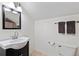 Simple bathroom with a black vanity, tile floors, a standard toilet, and a large mirror at 832 N Summerlin Ave, Orlando, FL 32803