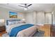 Bright bedroom features a ceiling fan, neutral walls, and a comfortable bed with stylish blue accents at 832 N Summerlin Ave, Orlando, FL 32803