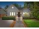 Charming home exterior with lush landscaping, stone accents, and a welcoming arched entryway at 832 N Summerlin Ave, Orlando, FL 32803