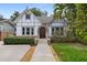 Charming home featuring manicured lawn, stonework, and a beautiful arched entryway at 832 N Summerlin Ave, Orlando, FL 32803