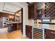 Gourmet kitchen featuring a wine fridge, custom cabinetry, and stainless steel appliances at 832 N Summerlin Ave, Orlando, FL 32803