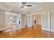Open-concept area with hardwood floors, large glass pane doors, and a view into the kitchen and dining room at 832 N Summerlin Ave, Orlando, FL 32803