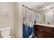 Bathroom with shower/tub combo, granite countertop, and dark brown vanity at 860 Oak Dr, Groveland, FL 34736
